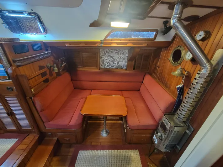 Searcher Yacht Photos Pics Cozy 1981 Tayana Vancouver 42 yacht interior with red seating and wooden accents.