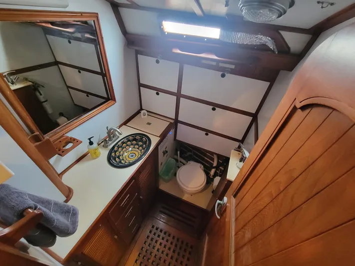 Searcher Yacht Photos Pics 1981 Tayana Vancouver 42 yacht bathroom with wooden accents and decorative sink.