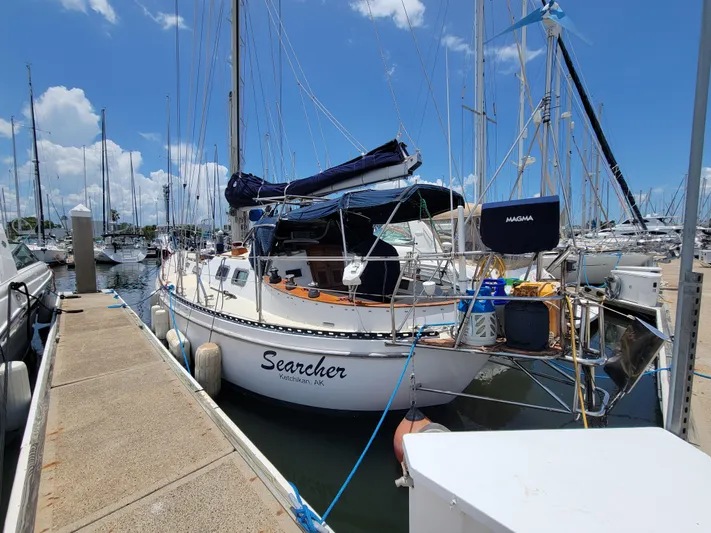Searcher Yacht Photos Pics 1981 Tayana Vancouver 42 sailboat docked at marina under clear blue sky.