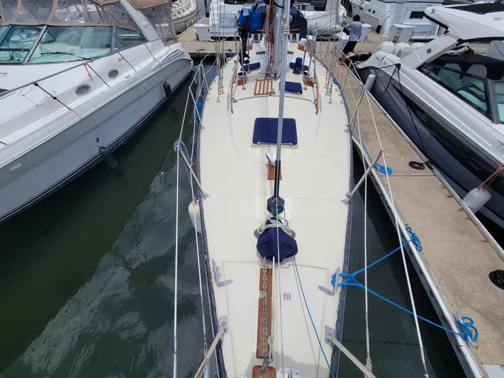 Searcher Yacht Photos Pics 1981 Tayana Vancouver 42 sailboat docked between other boats at a marina.