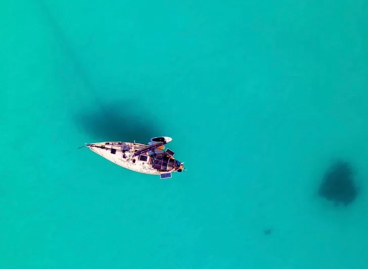 Searcher Yacht Photos Pics Aerial view of 1981 Tayana Vancouver 42 sailboat on turquoise water.