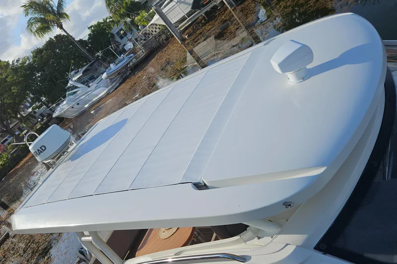  Yacht Photos Pics Nimbus Weekender 9 boat roof, 2020 model, docked near palm trees and other boats.