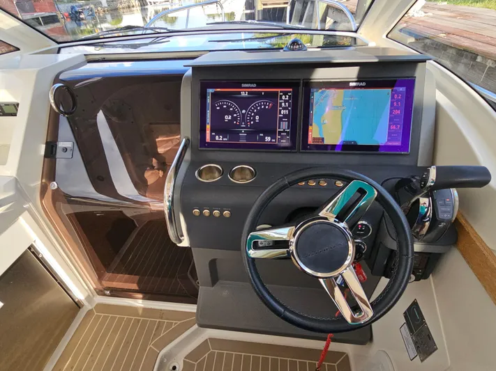  Yacht Photos Pics Cockpit of 2020 Nimbus Weekender 9 with modern navigation displays and steering wheel.