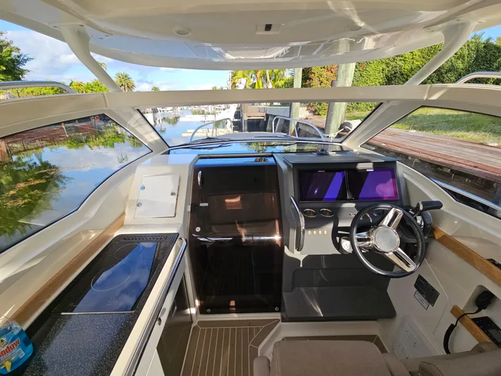  Yacht Photos Pics 2020 Nimbus Weekender 9 boat interior with modern helm, sleek design, and scenic waterway view.