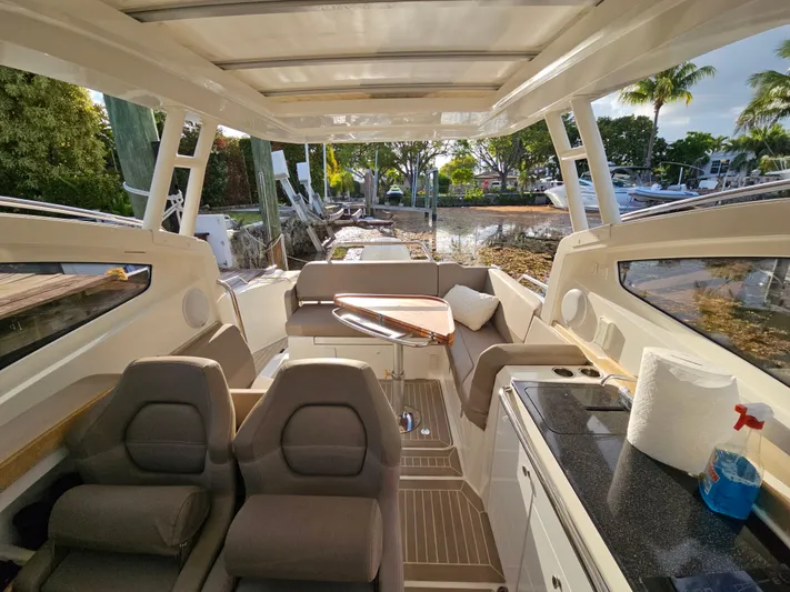  Yacht Photos Pics Interior of 2020 Nimbus Weekender 9 boat with seating, table, and kitchenette.