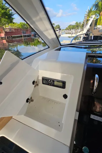 Yacht Photos Pics 2020 Nimbus Weekender 9 boat dashboard with open storage compartment and control panel.