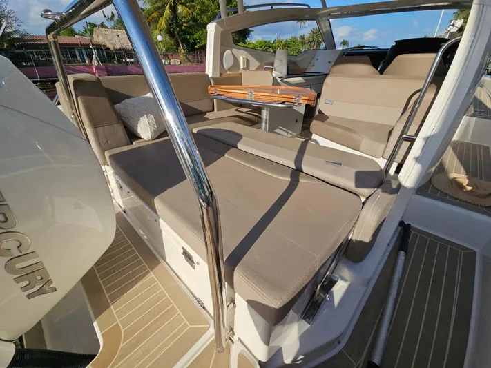  Yacht Photos Pics 2020 Nimbus Weekender 9 boat interior with beige seating and wooden table.