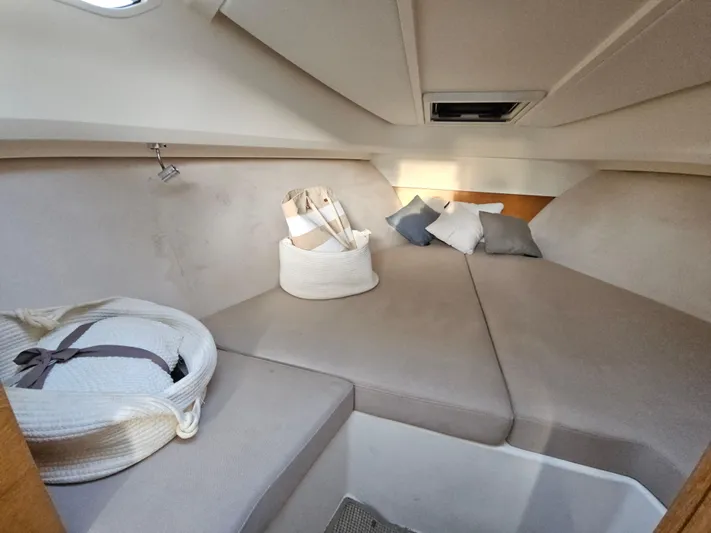  Yacht Photos Pics Cozy interior cabin of 2020 Nimbus Weekender 9 with cushions and storage baskets.