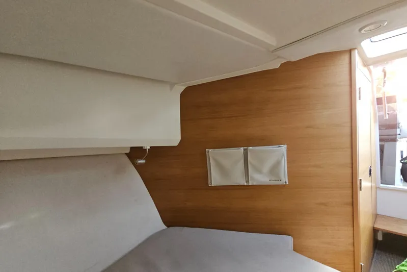  Yacht Photos Pics Interior of 2020 Nimbus Weekender 9 boat with wooden paneling and cozy sleeping area.