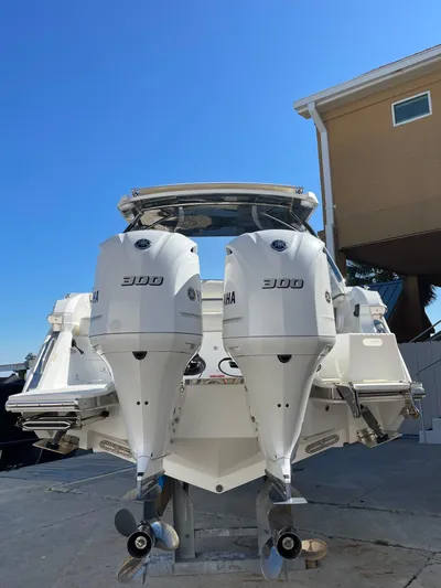  Yacht Photos Pics 2021 Cobalt 30SC Outboard with dual engines, docked under clear blue sky.