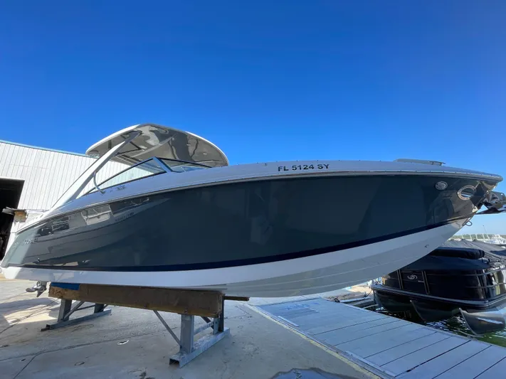  Yacht Photos Pics 2021 Cobalt 30SC Outboard boat on dock under clear blue sky.