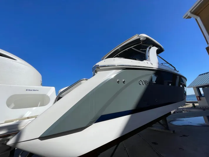  Yacht Photos Pics 2021 Cobalt 30SC Outboard boat with sleek design under clear blue sky.