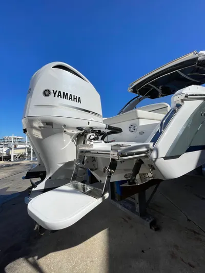  Yacht Photos Pics 2021 Cobalt 30SC Outboard with Yamaha engine, docked under clear blue sky.