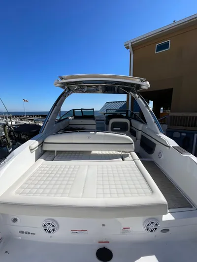  Yacht Photos Pics 2021 Cobalt 30SC Outboard boat with spacious deck and seating, docked under clear blue sky.