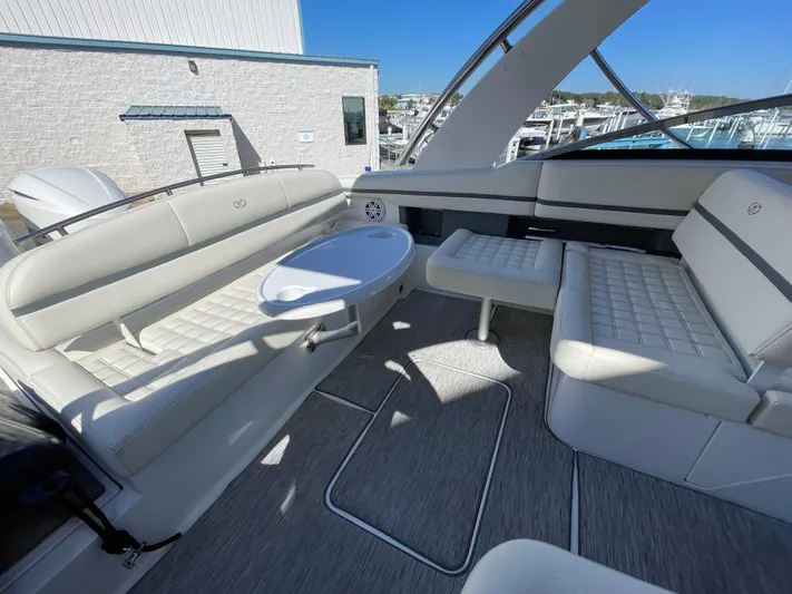  Yacht Photos Pics 2021 Cobalt 30SC Outboard boat interior with white seating and table.