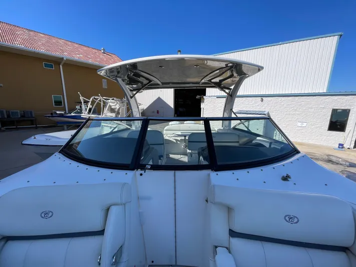  Yacht Photos Pics 2021 Cobalt 30SC Outboard boat with sleek design, docked outdoors under clear blue sky.