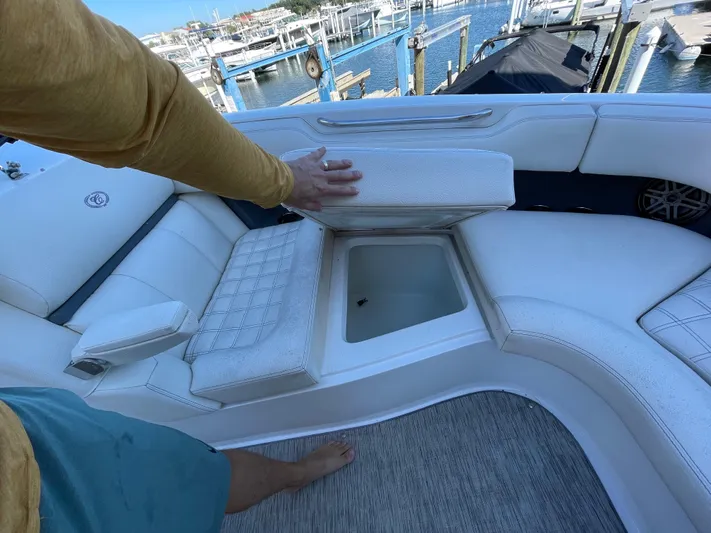  Yacht Photos Pics 2021 Cobalt 30SC Outboard boat with open storage compartment, docked at marina.