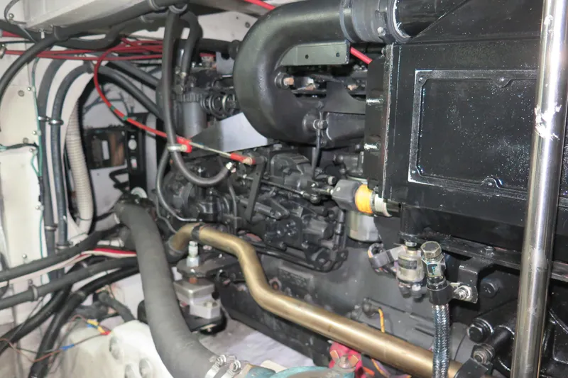 Mokikem Yacht Photos Pics Engine compartment of a 1995 Bayliner 3988 Command Bridge Motoryacht, showcasing mechanical components.