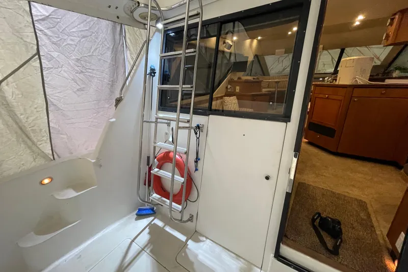 Mokikem Yacht Photos Pics Covered aft cockpit with ladder to command bridge, door to engine room and sliding door to salon.