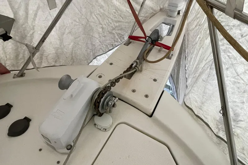 Mokikem Yacht Photos Pics Anchor loaded in anchor roller on bow sprit with all chain anchor rode. Muir anchor windlass with footswitches and remote control at helm.