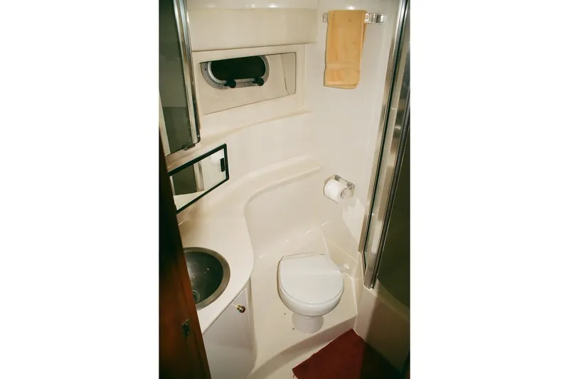 Mokikem Yacht Photos Pics Bathroom interior of 1995 Bayliner 3988 Command Bridge Motoryacht, featuring toilet and sink.