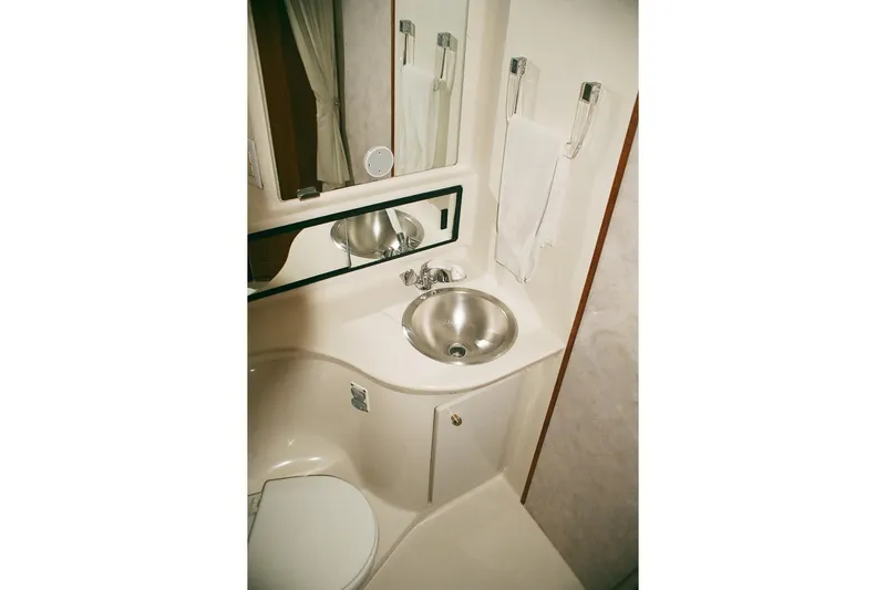 Mokikem Yacht Photos Pics Bathroom interior of 1995 Bayliner 3988 Command Bridge Motoryacht with sink and mirror.