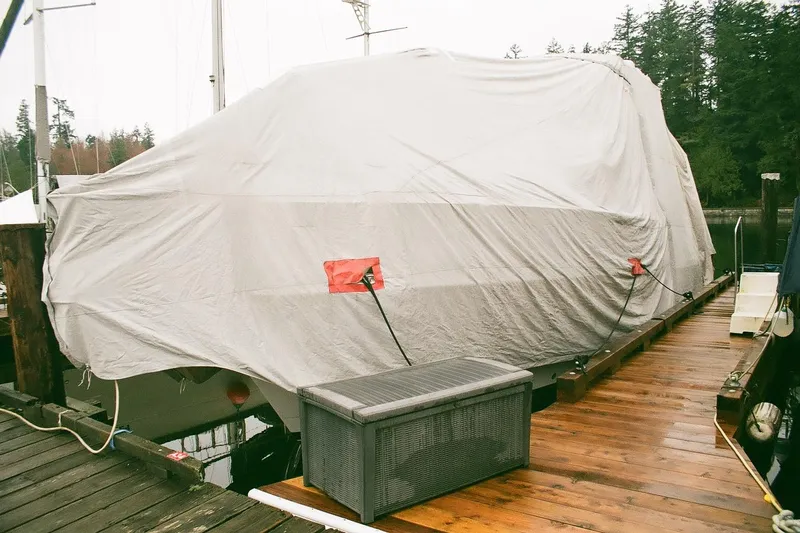 Mokikem Yacht Photos Pics Covered 1995 Bayliner 3988 Command Bridge Motoryacht docked on a wooden pier.