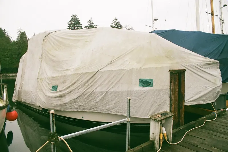 Mokikem Yacht Photos Pics 1995 Bayliner 3988 Command Bridge Motoryacht covered at dockside, wrapped in protective tarp.