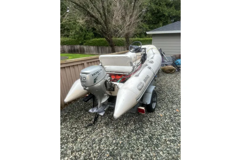 Mokikem Yacht Photos Pics Inflatable boat with Honda outboard motor on gravel driveway.