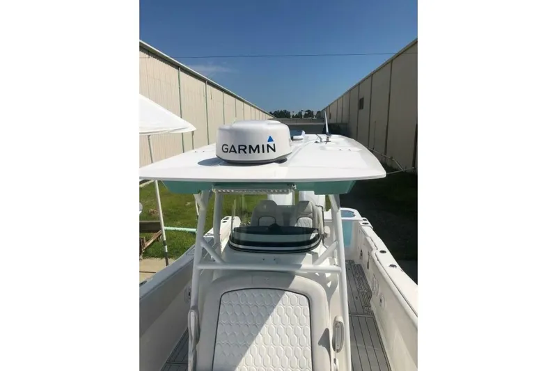  Yacht Photos Pics 2021 Sea Fox 288 Commander boat with Garmin radar, docked near a warehouse.