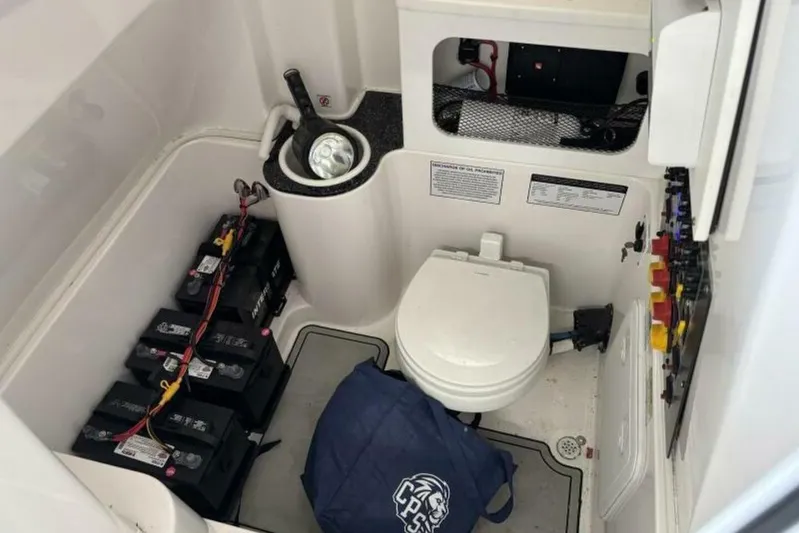  Yacht Photos Pics 2021 Sea Fox 288 Commander boat interior with toilet, batteries, and storage area.