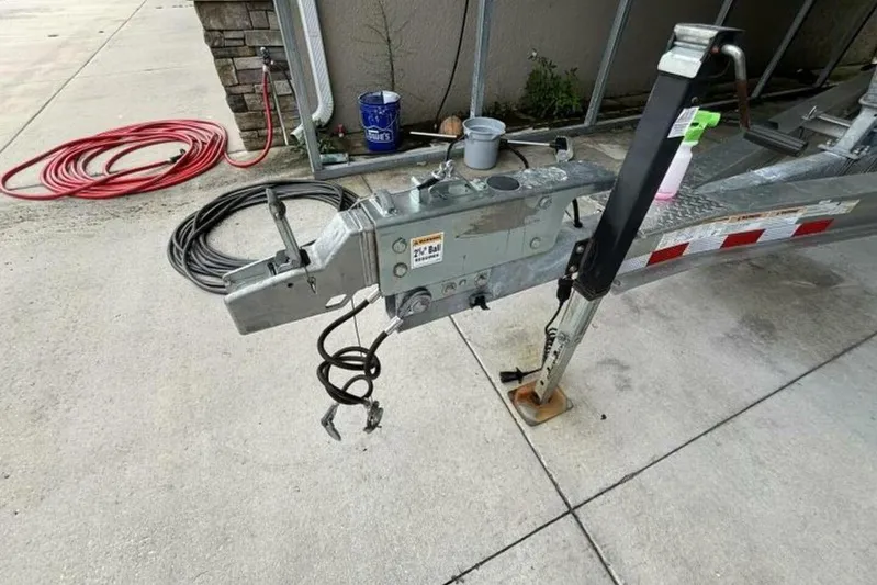  Yacht Photos Pics Trailer hitch of a 2021 Sea Fox 288 Commander boat on concrete surface.