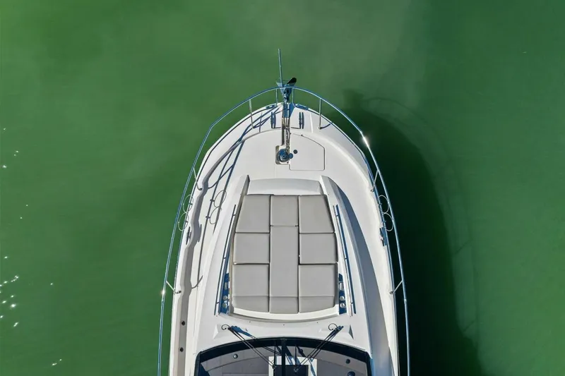 No Patience Yacht Photos Pics Top view of 2022 Prestige 520 yacht on calm green water.