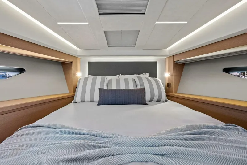 No Patience Yacht Photos Pics Luxurious bedroom interior of 2022 Prestige 520 yacht with modern design and cozy bedding.