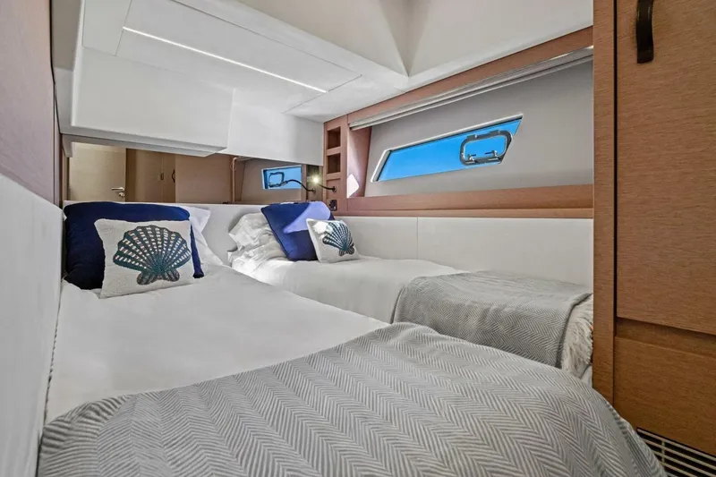 No Patience Yacht Photos Pics Luxurious twin cabin interior of 2022 Prestige 520 yacht with elegant bedding and decor.