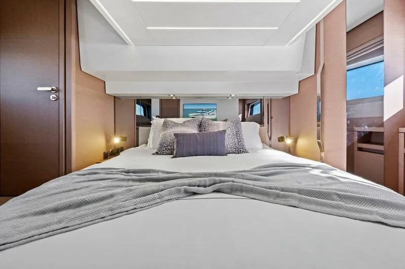 No Patience Yacht Photos Pics Luxurious bedroom interior of 2022 Prestige 520 yacht, featuring elegant bedding and modern design.