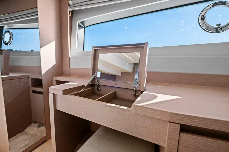 No Patience Yacht Photos Pics Luxurious interior of 2022 Prestige 520 yacht with elegant wooden vanity and window view.