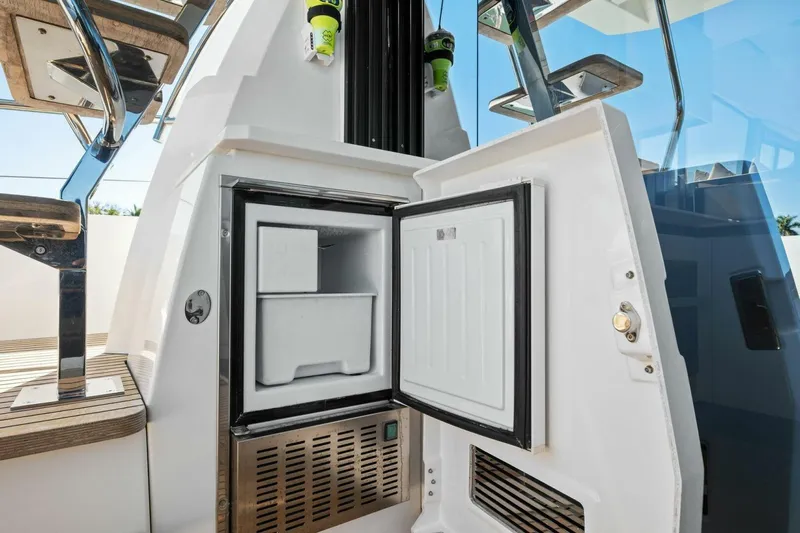 No Patience Yacht Photos Pics Open mini fridge on 2022 Prestige 520 yacht, showcasing modern design and functionality.