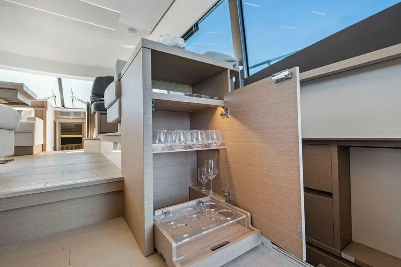 No Patience Yacht Photos Pics Luxurious interior of 2022 Prestige 520 yacht with open cabinet and glassware.