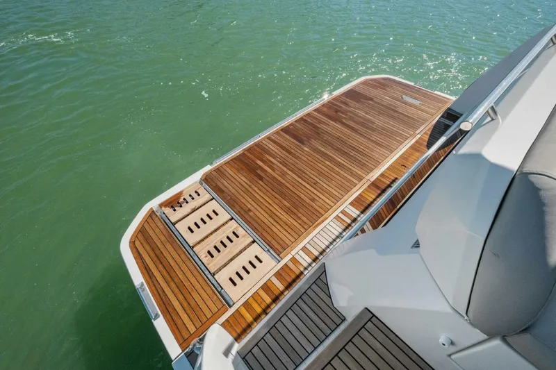 No Patience Yacht Photos Pics Luxury yacht Prestige 520, 2022 model, featuring elegant teak deck over water.