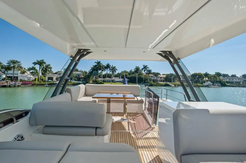No Patience Yacht Photos Pics Luxurious 2022 Prestige 520 yacht interior with elegant seating and scenic waterfront view.