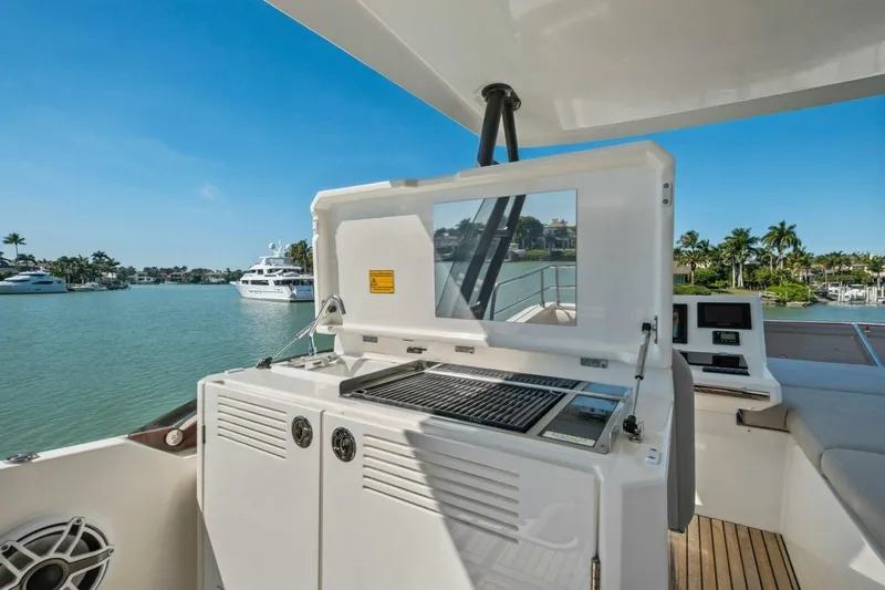 No Patience Yacht Photos Pics Luxury 2022 Prestige 520 yacht with outdoor grill and scenic waterfront view.