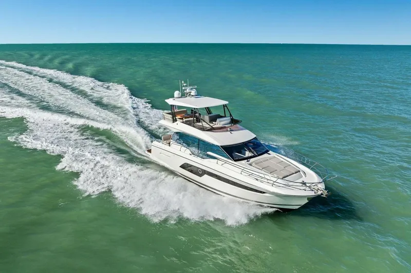 No Patience Yacht Photos Pics Luxury 2022 Prestige 520 yacht cruising on open sea under clear blue sky.