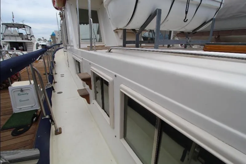  Yacht Photos Pics 1989 Grand Banks Classic yacht docked, showcasing side deck and windows.