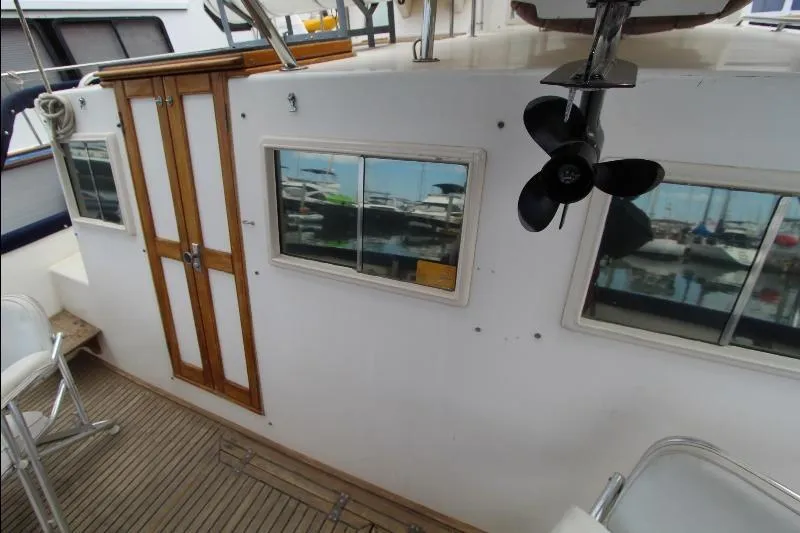  Yacht Photos Pics 1989 Grand Banks Classic boat deck with wooden doors and windows, marina view.