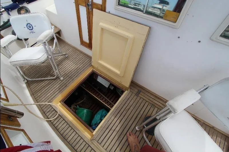  Yacht Photos Pics Open hatch on 1989 Grand Banks Classic boat deck with chairs and storage.