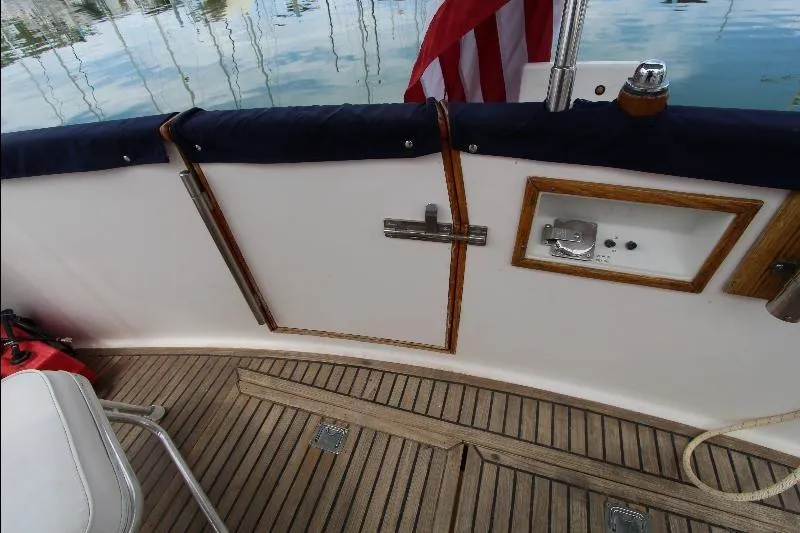  Yacht Photos Pics 1989 Grand Banks Classic boat deck with wooden flooring and American flag.