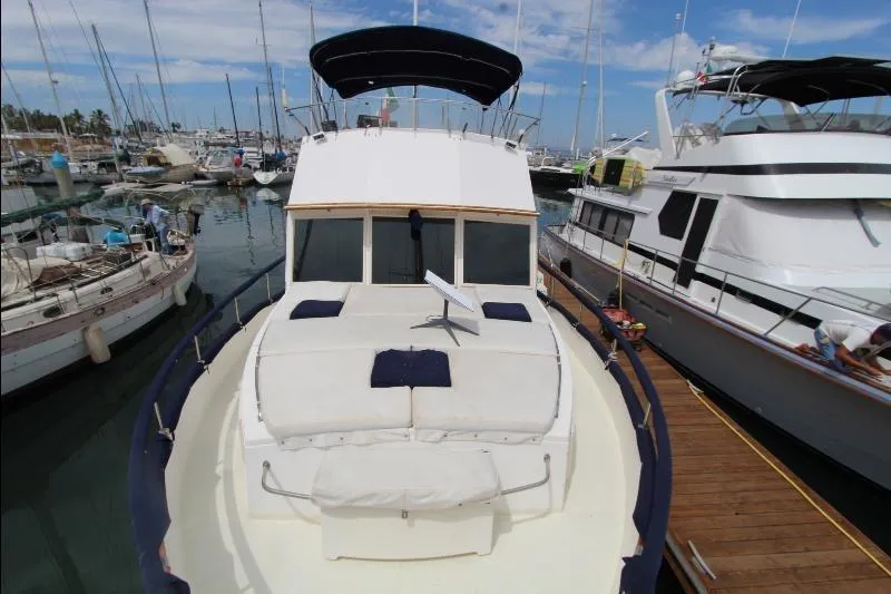  Yacht Photos Pics 1989 Grand Banks Classic yacht docked in a marina, featuring spacious deck seating.