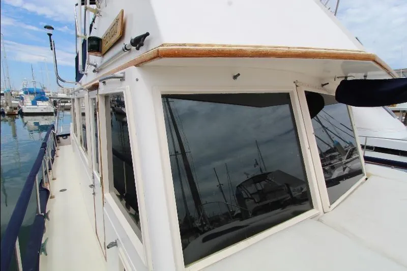  Yacht Photos Pics 1989 Grand Banks Classic yacht docked at marina, showcasing windows and deck details.
