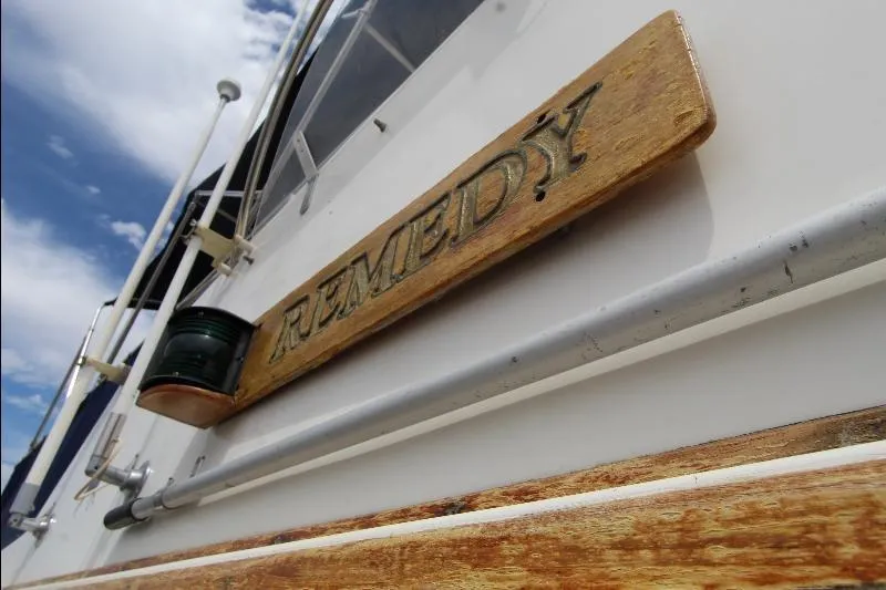  Yacht Photos Pics 1989 Grand Banks Classic boat with "Remedy" nameplate, wooden details, and clear sky background.